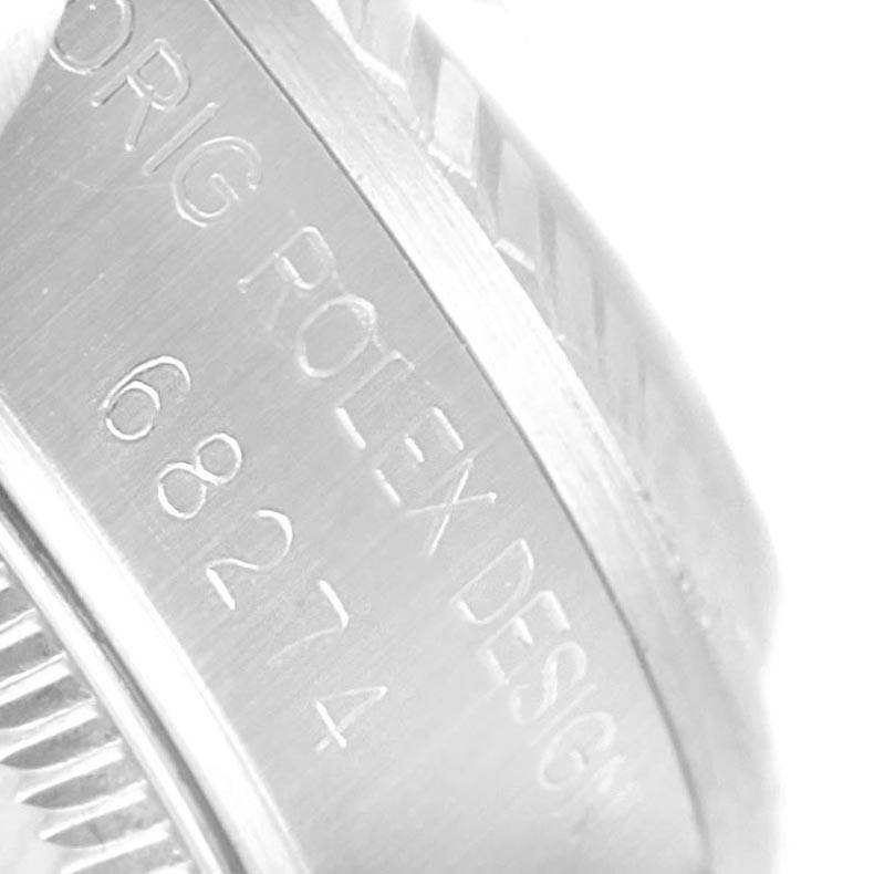This image shows a close-up of the side engraving on a Rolex Mid-Size 68274 Women's Stainless Steel Silver Dial 68274 Women's Stainless Steel Silver Dial model.