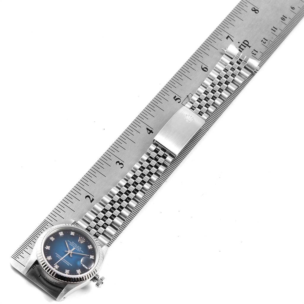 The image shows a Rolex Mid-Size 68274 Women's Stainless Steel Blue Dial 68274 Women's Stainless Steel Blue Dial watch laying flat against a ruler, displaying its face and bracelet.