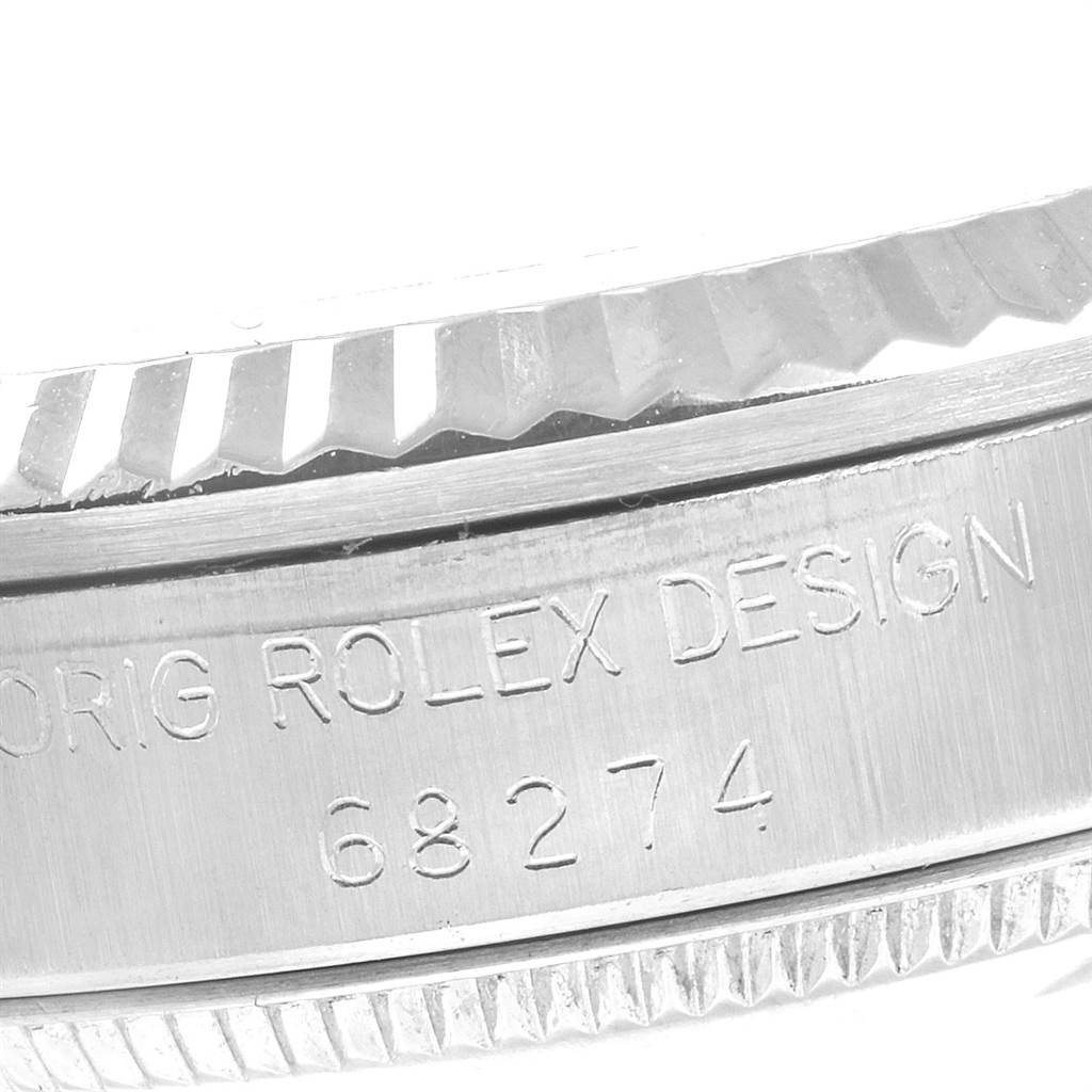 This close-up image shows the model number and part of the bezel of a Mid-Size Rolex watch.