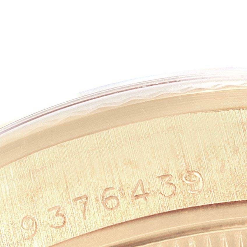 The image shows a close-up view of the outer edge and casing of a mid-size Rolex watch, displaying a part of the serial number.