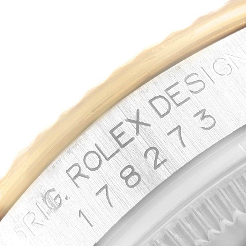 Close-up of the bezel and engraved serial number on a Mid-Size Rolex watch model.