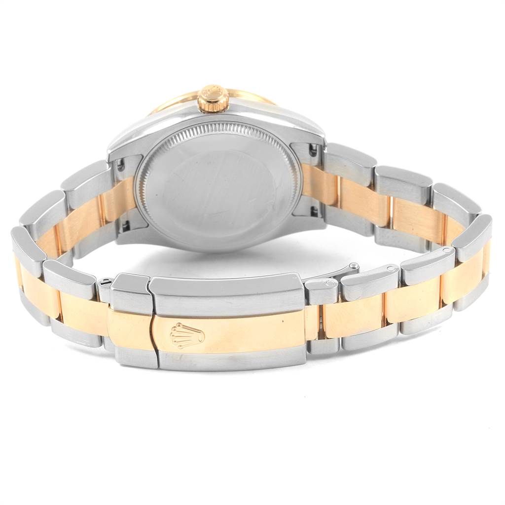 The image shows the back view of a Mid-Size Rolex watch, highlighting the steel and gold bracelet and closed clasp.