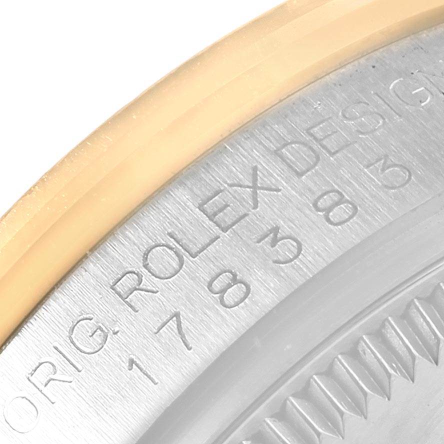 The image shows a close-up of the side of a mid-size Rolex watch, focusing on the engraved text and part of the bezel.