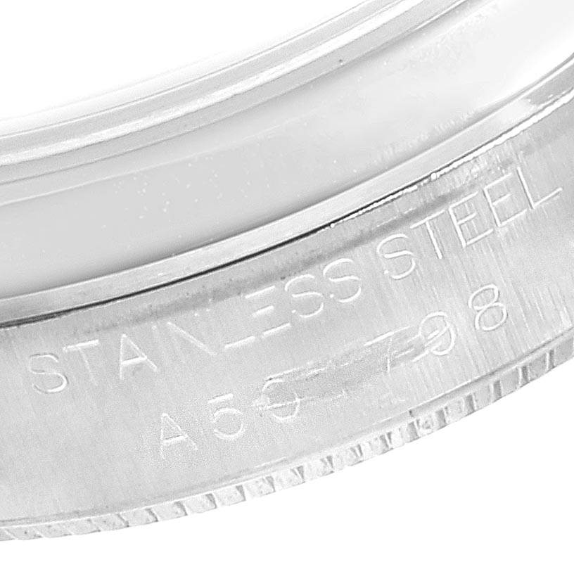 This is a close-up view of the side of a Mid-Size Rolex watch, showing the "STAINLESS STEEL" engraving.