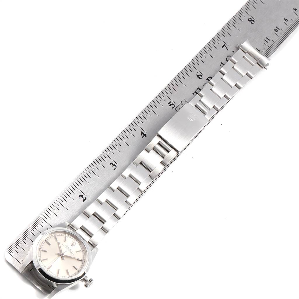 The image shows a horizontal view of a Mid-Size Rolex watch with its entire band aligned next to a ruler.