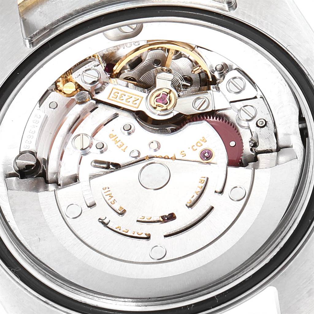 This image shows the internal mechanism of a Mid-Size Rolex watch from a close-up angle, highlighting its intricate components.