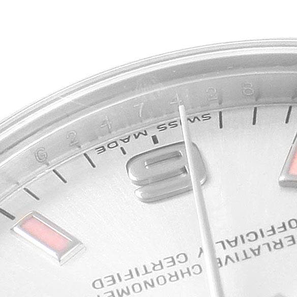 This image shows a close-up of the dial and part of the bezel angle of a Mid-Size Rolex watch, highlighting the hour markers, and second hand.
