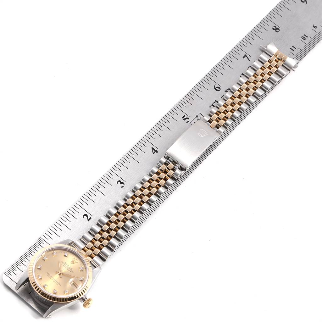 The Rolex Mid-Size 68273 Women's Steel and Gold (two tone) Champagne Dial 68273 Women's Steel and Gold (two tone) Champagne Dial watch is shown flat, featuring the face, bracelet, and clasp, measured against a ruler.
