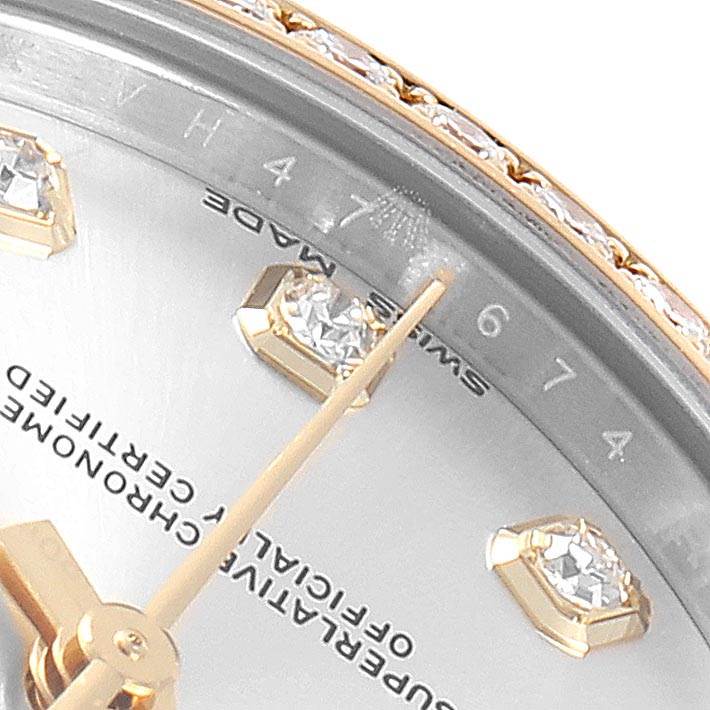 This close-up angle of the Rolex Mid-Size 178383 Women's Steel and Gold (two tone) Silver Dial 178383 Women's Steel and Gold (two tone) Silver Dial watch shows part of the dial, diamond hour markers, minute hand, and a portion of the bezel.