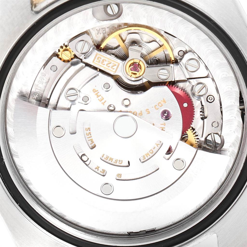 This image shows the movement mechanism of a Mid-Size Rolex watch from an internal angle with detailed gears and components visible.