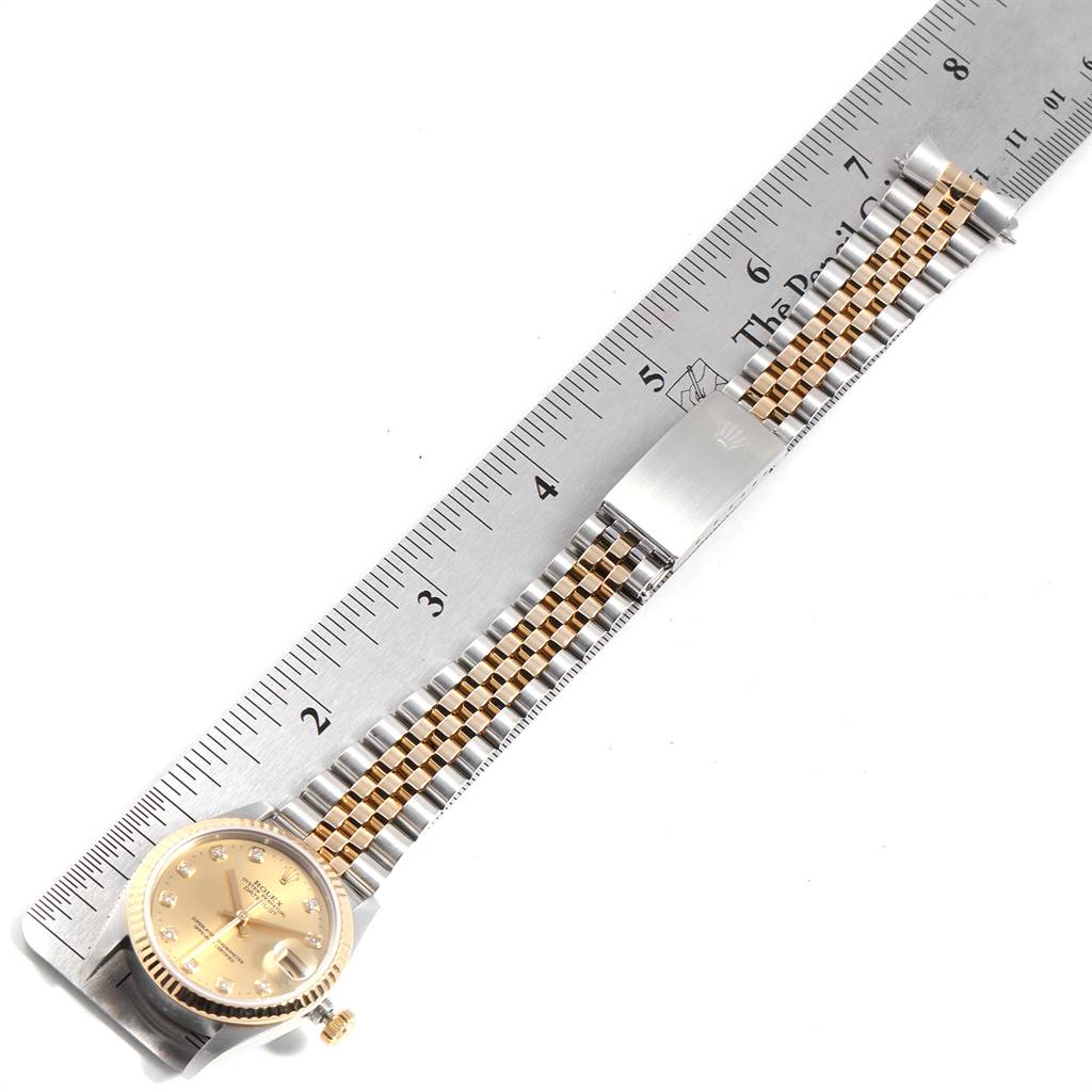 The Rolex Mid-Size 68273 Women's Steel and Gold (two tone) Champagne Dial 68273 Women's Steel and Gold (two tone) Champagne Dial model watch is shown laid flat with a measuring ruler, displaying the face and full metal bracelet.