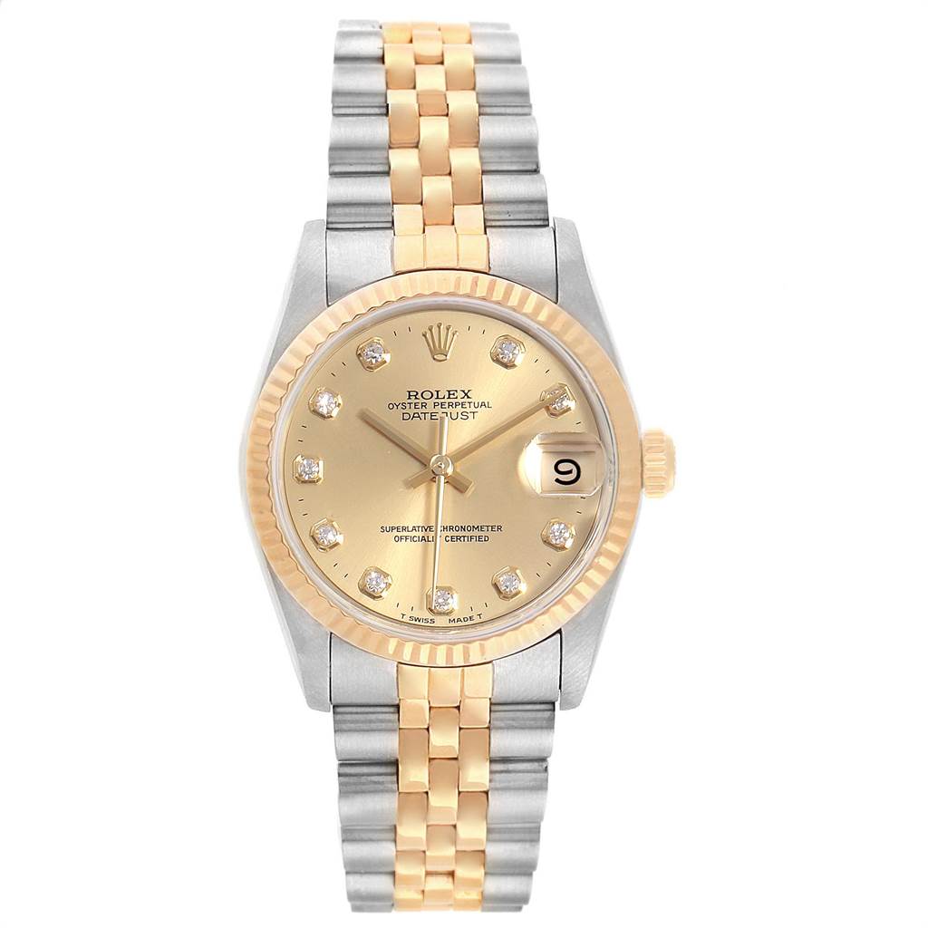The Mid-Size Rolex watch is shown from a top-down angle, featuring its dial, bracelet, and date function.