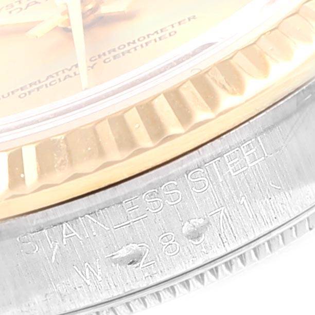 This image shows a close-up of the bezel and part of the case of a Mid-Size Rolex watch, highlighting the "STAINLESS STEEL" engraving.