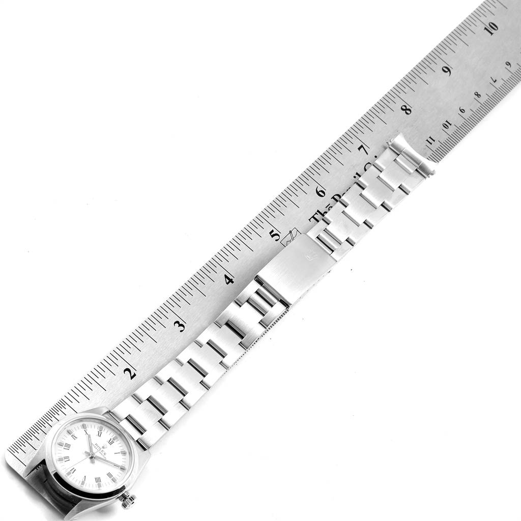 This image shows a top-down view of a Mid-Size Rolex watch featuring the face and full length of the bracelet measured against a ruler.