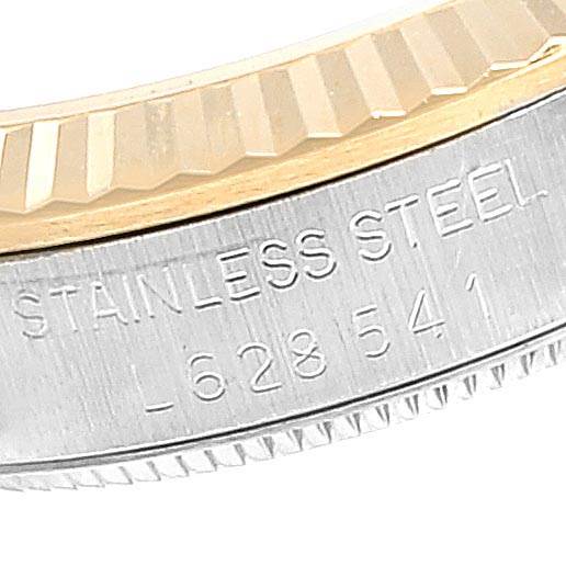 The image shows a close-up of the side case and bezel of a mid-size Rolex watch, highlighting the stainless steel engraving and model number.