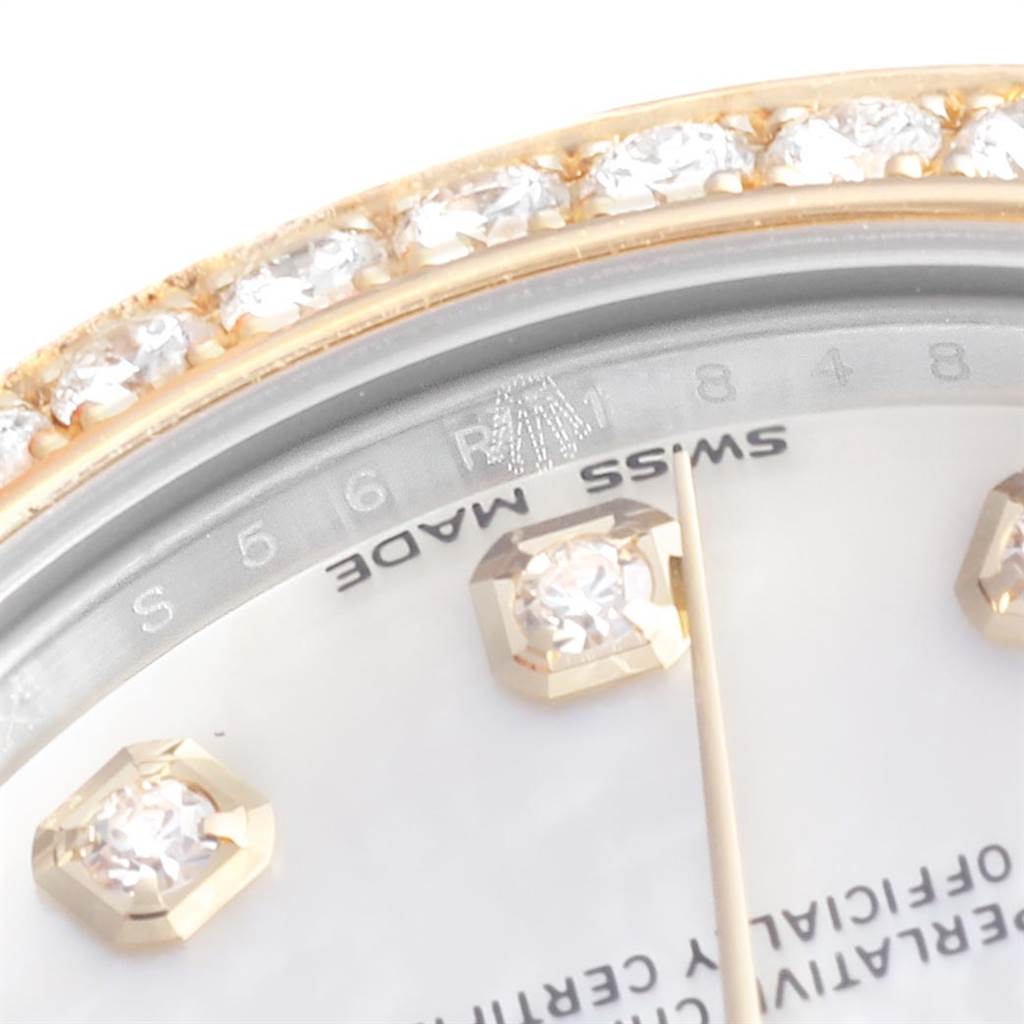 The image shows a close-up of the Rolex Mid-Size 178383 Women's Steel and Gold (two tone) Mother of Pearl Dial 178383 Women's Steel and Gold (two tone) Mother of Pearl Dial model's diamond-accented bezel, part of the dial, and hour markers.