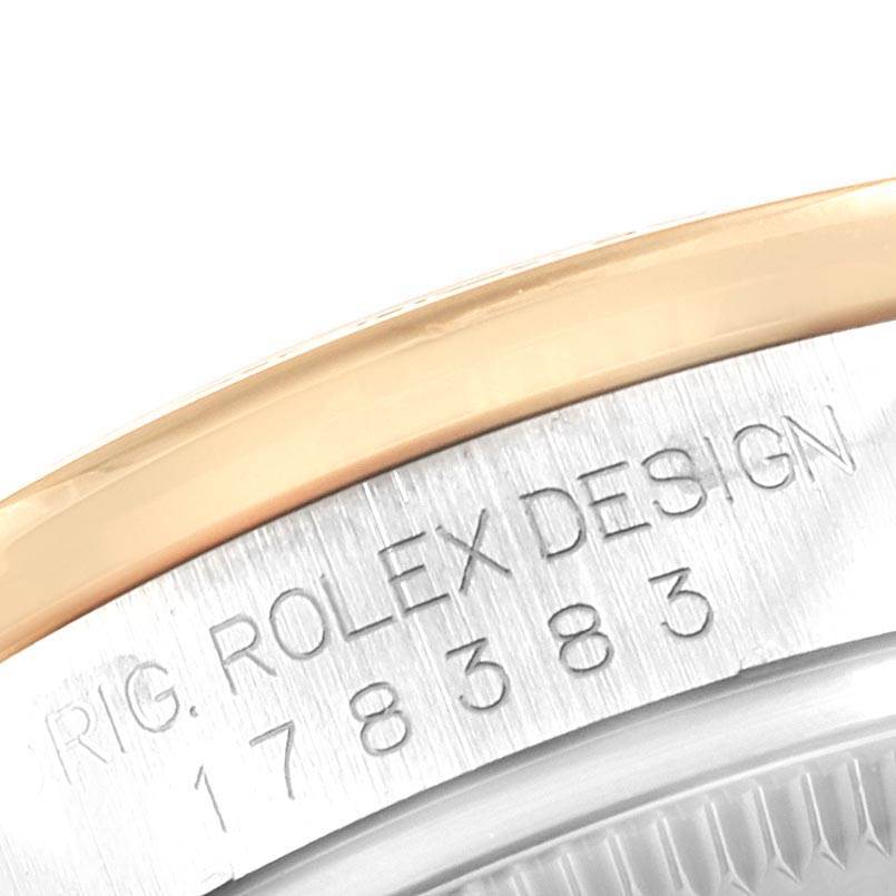 This image shows an angled close-up of the engraved side of a Rolex Mid-Size 178383 Women's Steel and Gold (two tone) Mother of Pearl Dial 178383 Women's Steel and Gold (two tone) Mother of Pearl Dial watch case, displaying the model number and "Rolex Design" text.