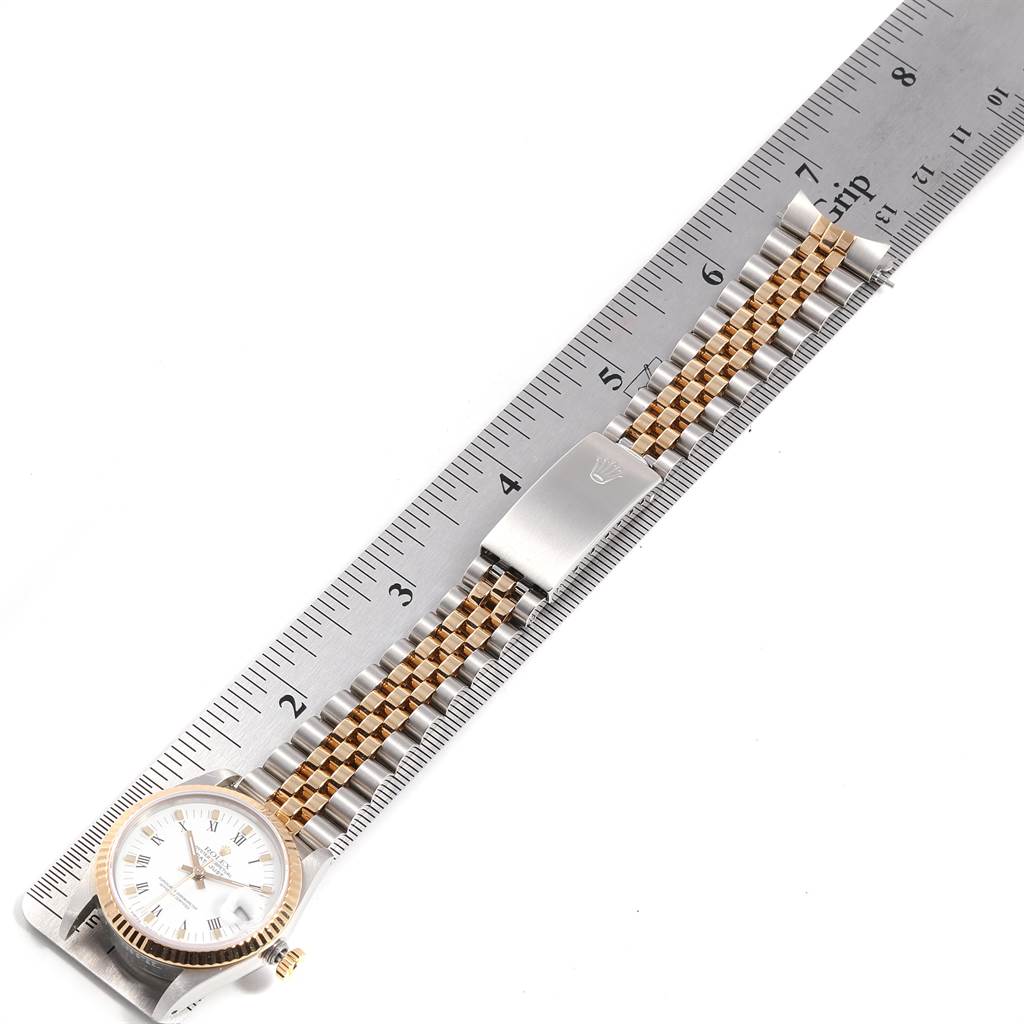 The image shows a full view of a Rolex Mid-Size 68273 Women
s Steel and Gold (two tone) White Dial 68273 Women
s Steel and Gold (two tone) White Dial model watch with a two-tone bracelet and ruler for scale reference.
