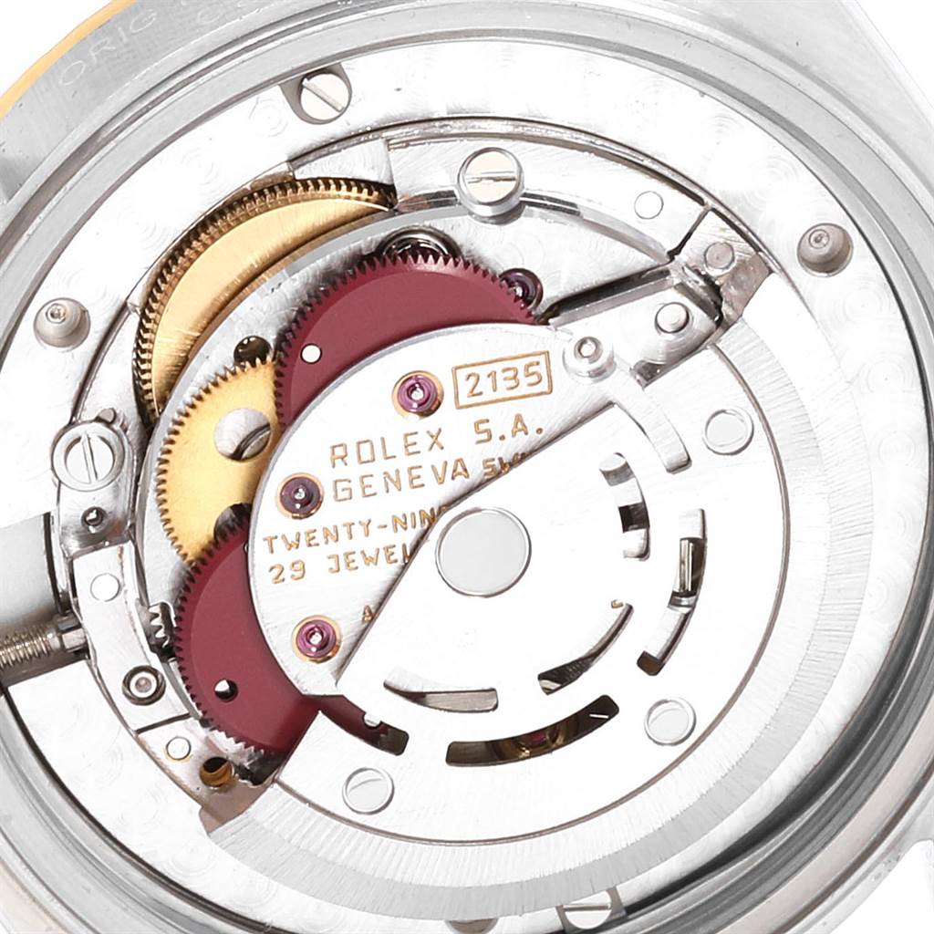 This image shows an internal view of the Rolex Mid-Size 68273 Women
s Steel and Gold (two tone) White Dial 68273 Women
s Steel and Gold (two tone) White Dial watch’s 2135 movement mechanism.