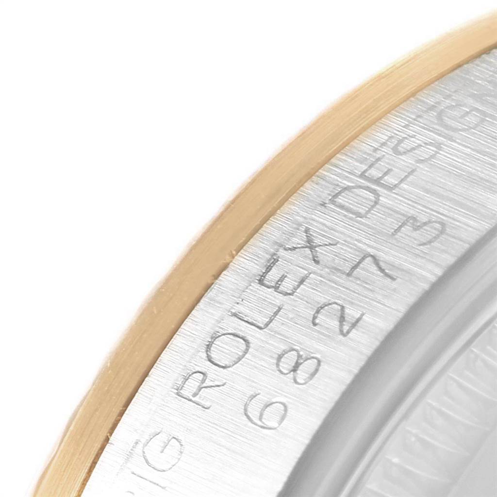 This image shows a close-up of the bezel and engraved edge of a Rolex Mid-Size 68273 Women
s Steel and Gold (two tone) White Dial 68273 Women
s Steel and Gold (two tone) White Dial model watch.