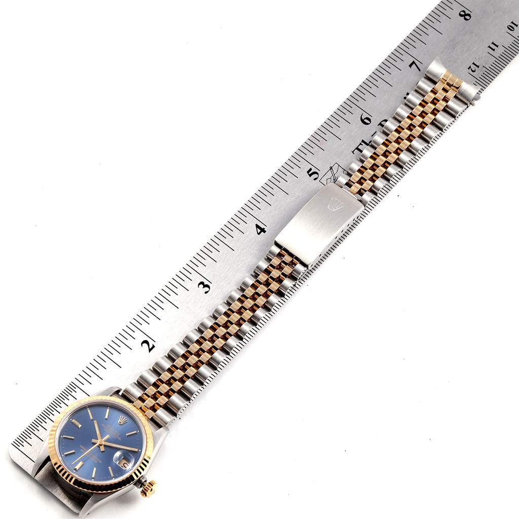 The image shows a Rolex Mid-Size 68273 Steel and Gold (two tone) Blue Dial 68273 Steel and Gold (two tone) Blue Dial watch from the top view, including the face, bezel, strap, and clasp alongside a ruler.