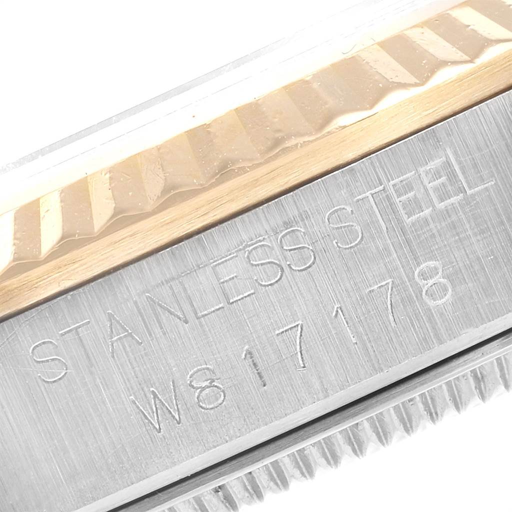 This image shows a close-up angle of the case side of a Mid-Size Rolex watch, highlighting the stainless steel material and textured edge.