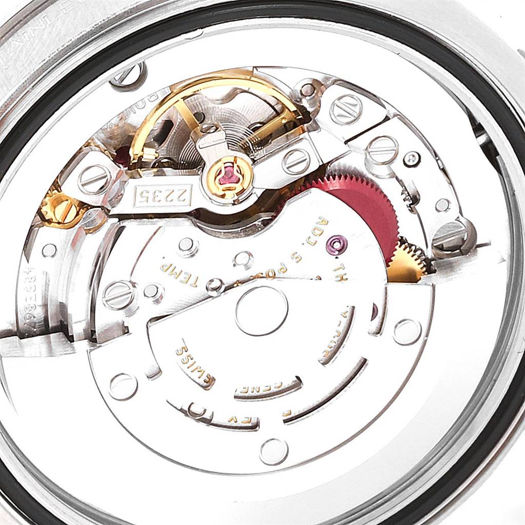The image shows the internal mechanical movement of a Mid-Size Rolex watch from a close-up, top-down angle.