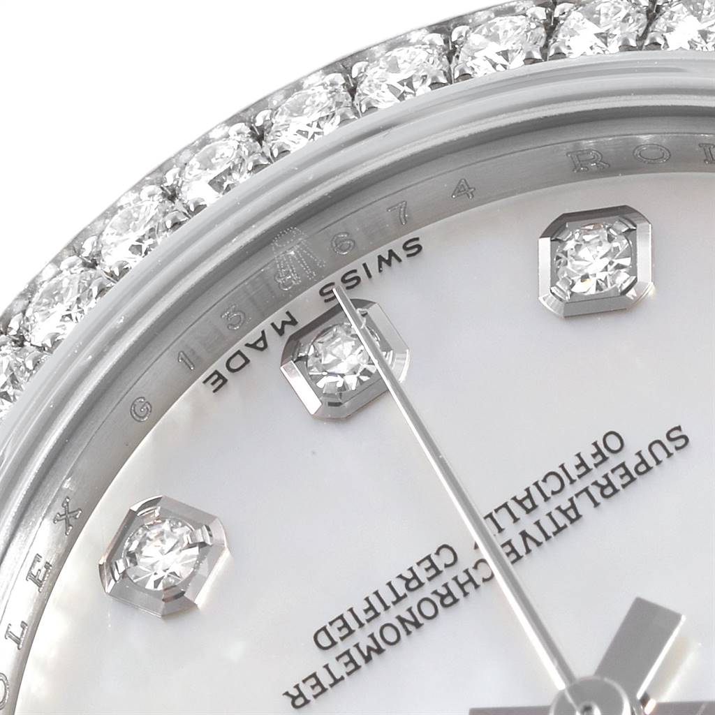 This image shows a close-up of the face and bezel with gemstones of a Mid-Size Rolex watch, highlighting the "Swiss Made" marking.