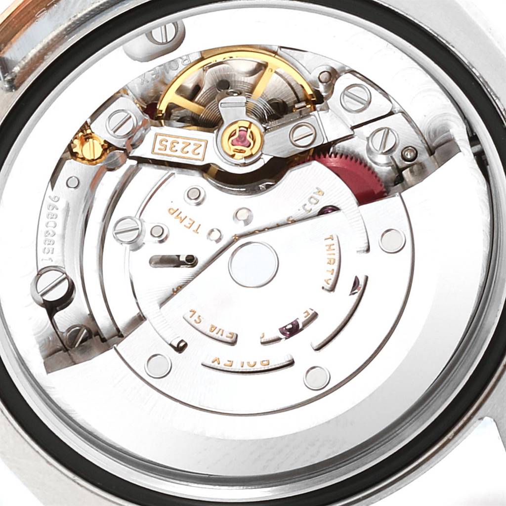 This image shows the intricate internal mechanism of a Mid-Size Rolex watch from a close-up, rear angle.