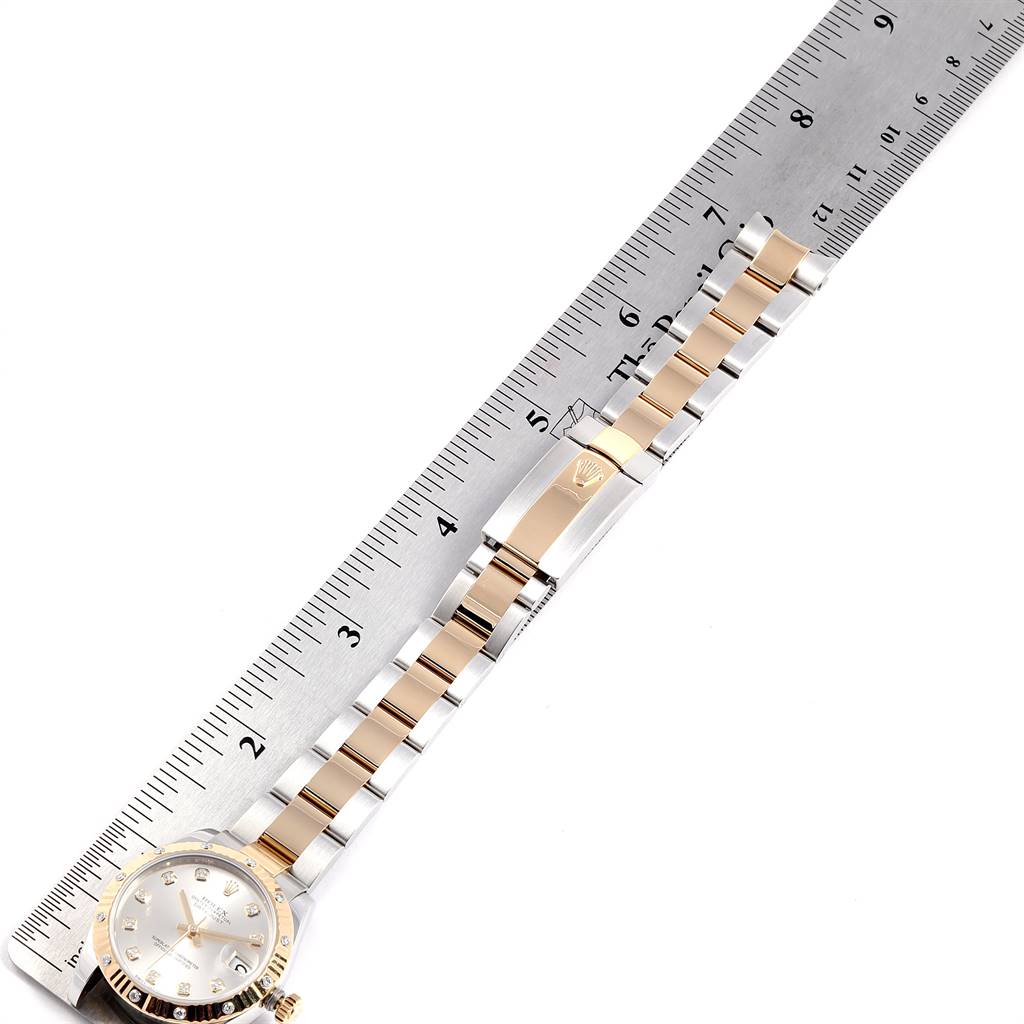 The image shows a measurement of the band and clasp of the Rolex Mid-Size 178313 Women's Stainless Steel Silver Dial 178313 Women's Stainless Steel Silver Dial watch, positioned next to a ruler.