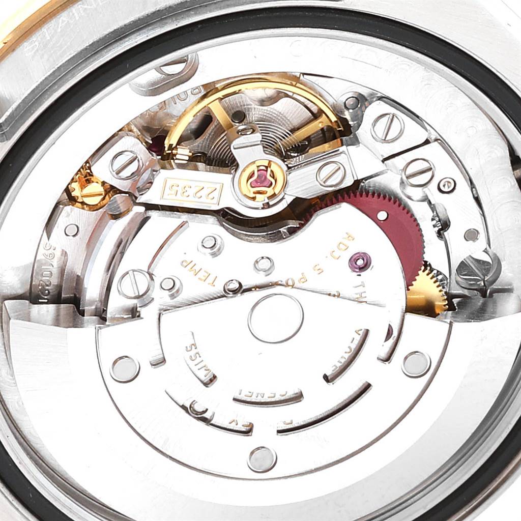 The image shows a close-up view of the movement mechanism inside a Mid-Size Rolex watch.