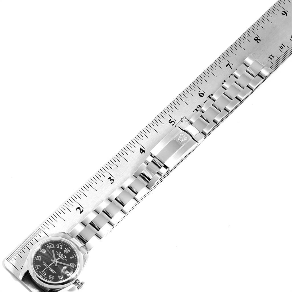 The image shows a Rolex Mid-Size 178240 Women's Stainless Steel Black Dial 178240 Women's Stainless Steel Black Dial watch laid next to a ruler, displaying the face, bracelet, and clasp.