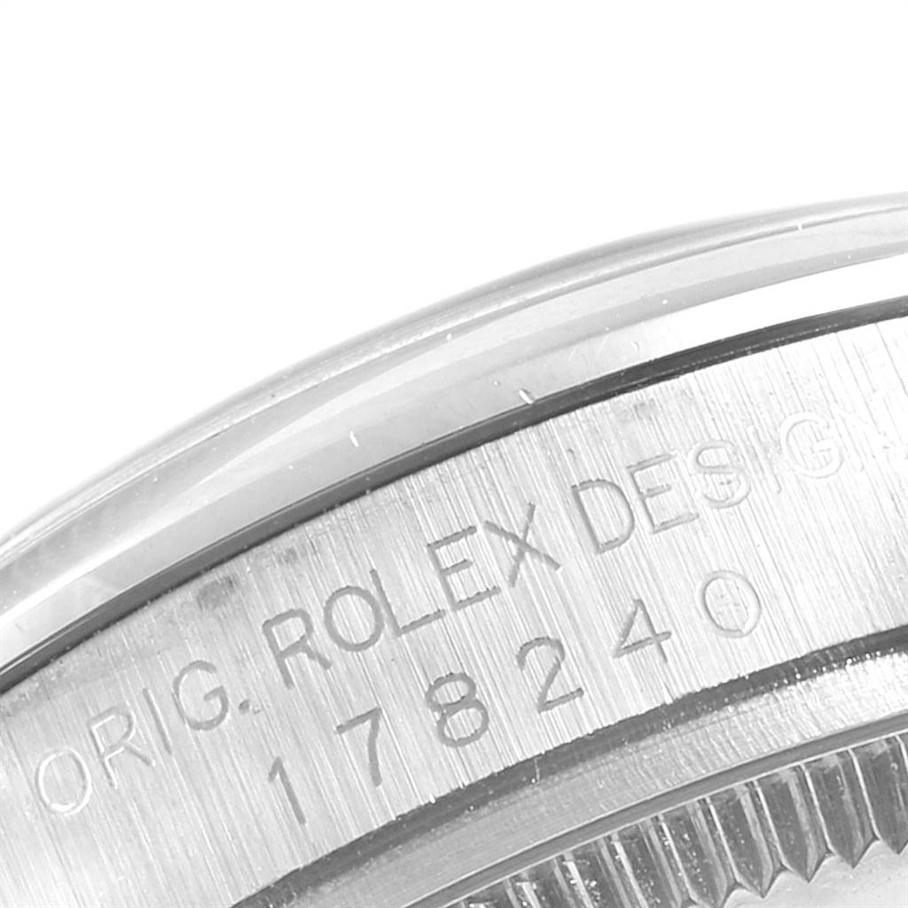 This close-up image shows the engraved side of the case back of a Mid-Size Rolex watch, featuring some serial numbers and text.