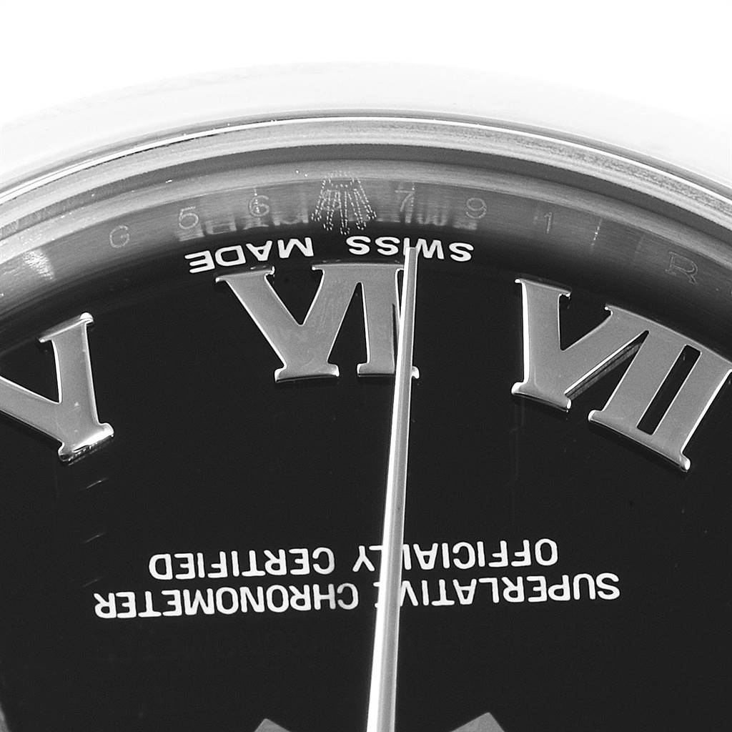 The image shows a close-up of the dial of a mid-size Rolex watch, highlighting the Roman numerals, "SWISS MADE" text, and part of the bezel.