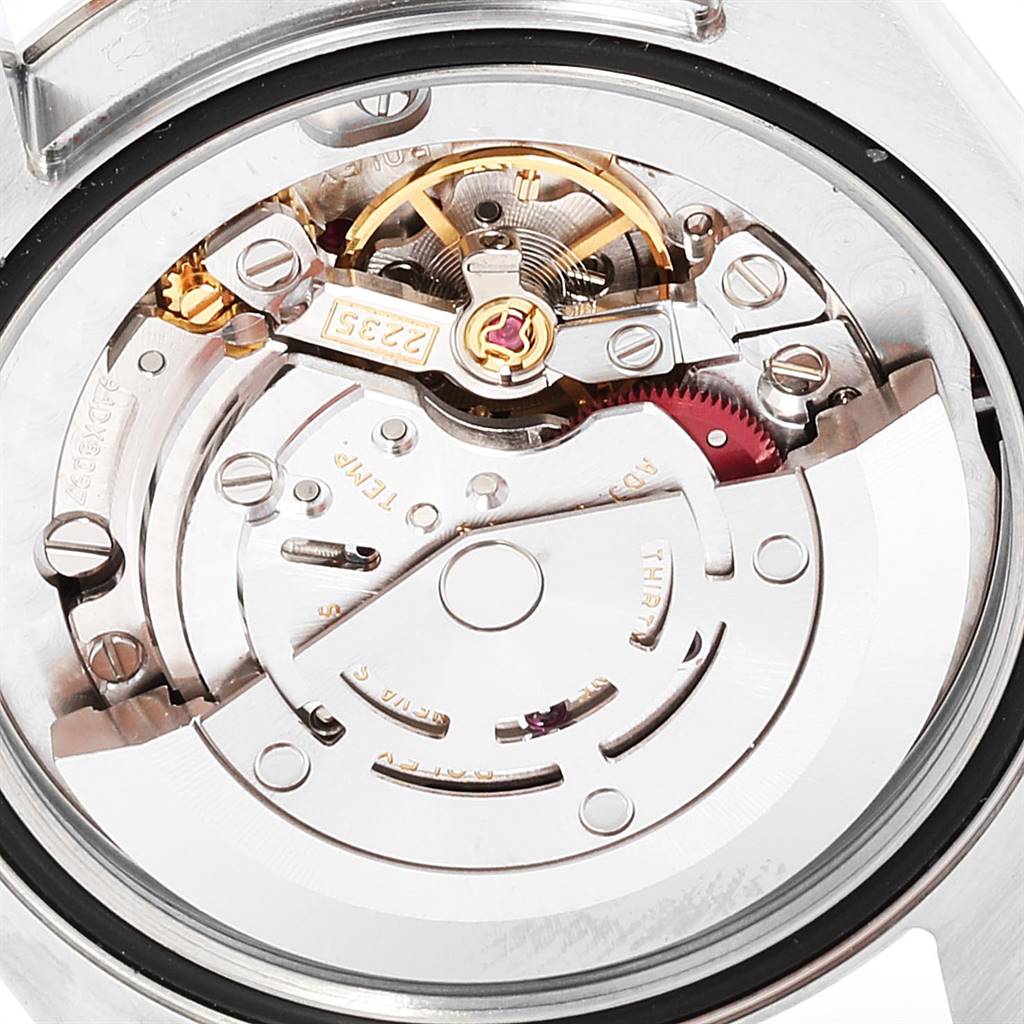 The image shows the inner mechanical movement of a Mid-Size Rolex watch from a top-down angle.
