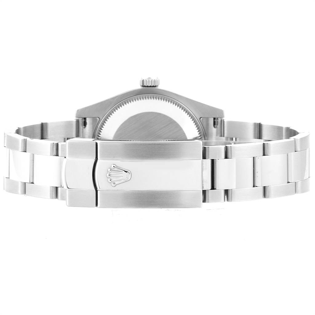 The image shows the backside of a Mid-Size Rolex watch, highlighting the metal bracelet and clasp with the Rolex crown logo.