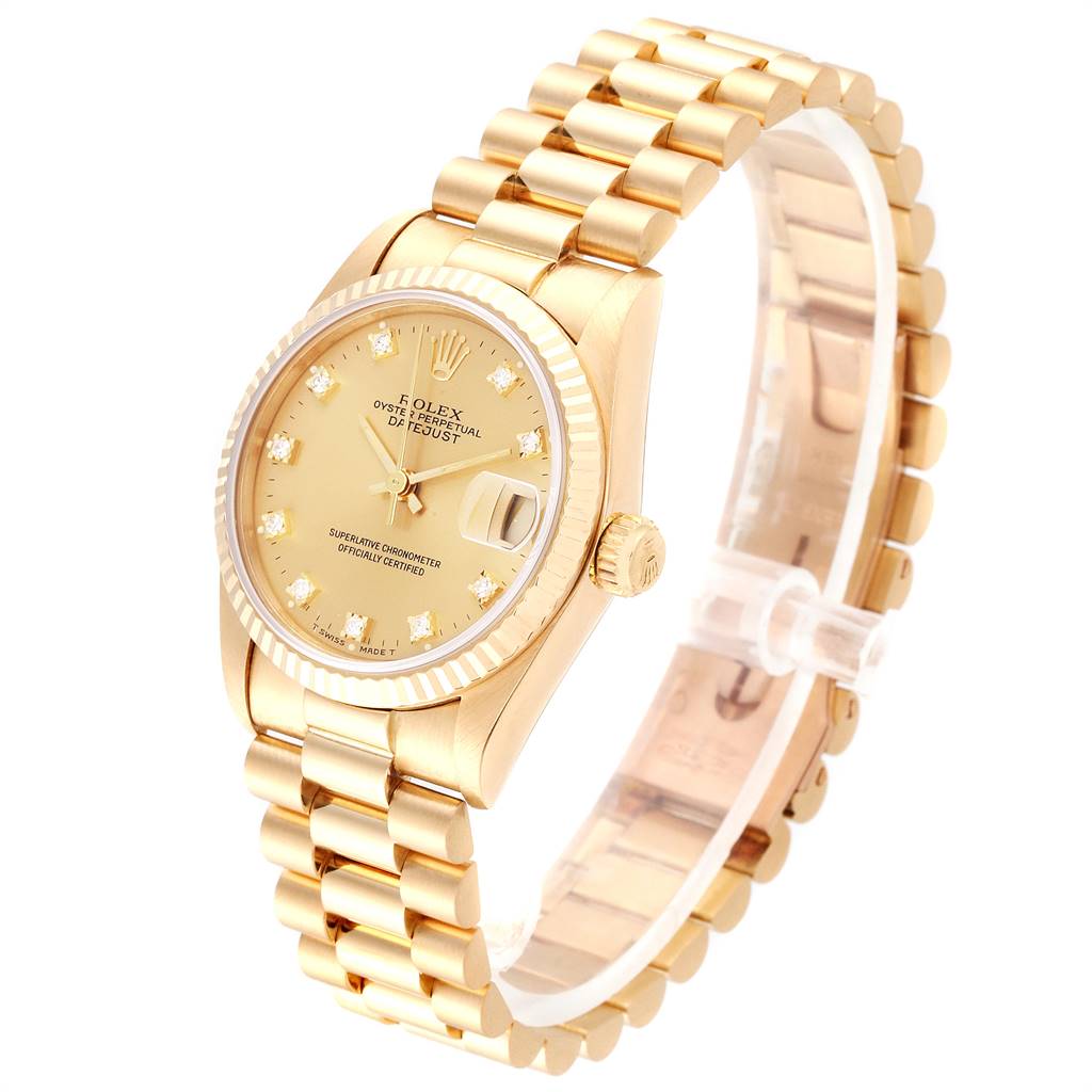 The Rolex Mid-Size 68278 Women's Yellow Gold Champagne Dial 68278 Women's Yellow Gold Champagne Dial watch is shown from a slight side angle, featuring its gold bracelet, case, and diamond-studded dial.