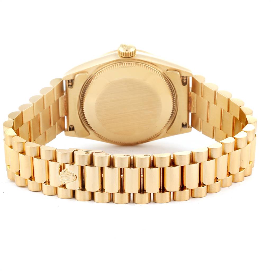 The image shows the back case and the bracelet of a Mid-Size Rolex watch in a gold finish.