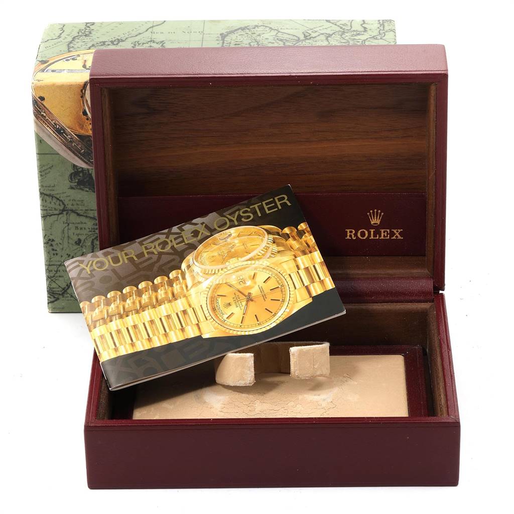 A Rolex Mid-Size 68278 Women's Yellow Gold Champagne Dial 68278 Women's Yellow Gold Champagne Dial watch box is open, displaying the logo and an instruction booklet inside.