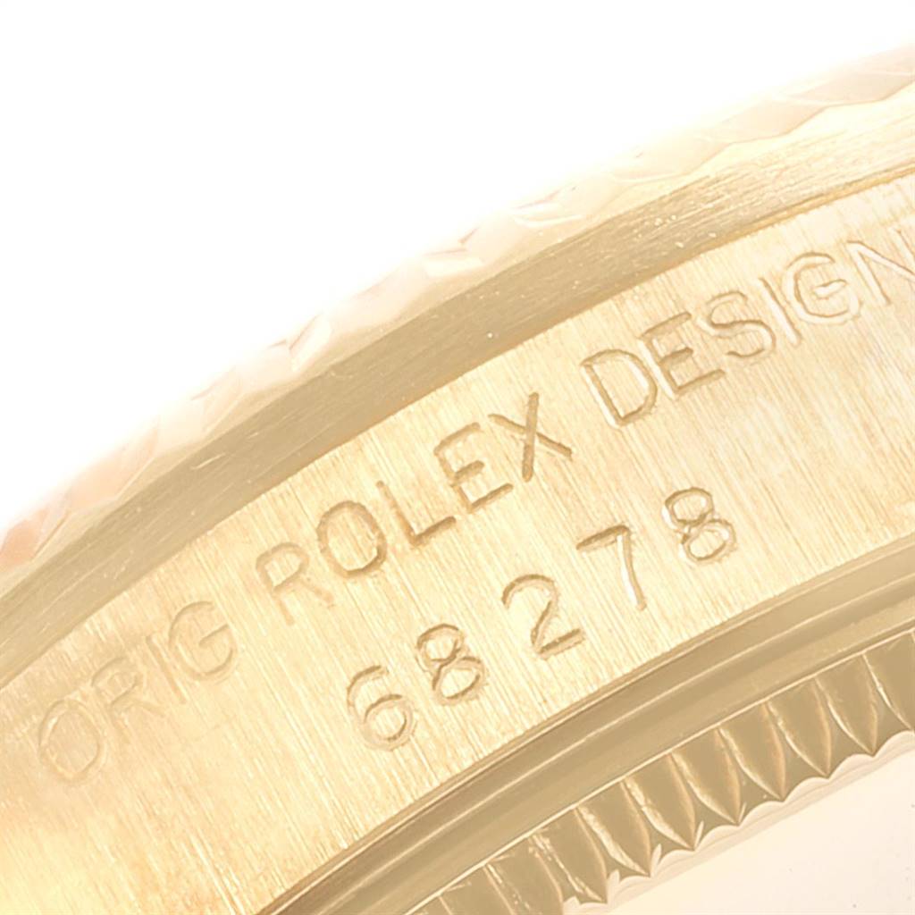 This close-up shows the engraved side of the bezel on a Rolex Mid-Size 68278 Women's Yellow Gold Champagne Dial 68278 Women's Yellow Gold Champagne Dial watch, highlighting the design and model number.
