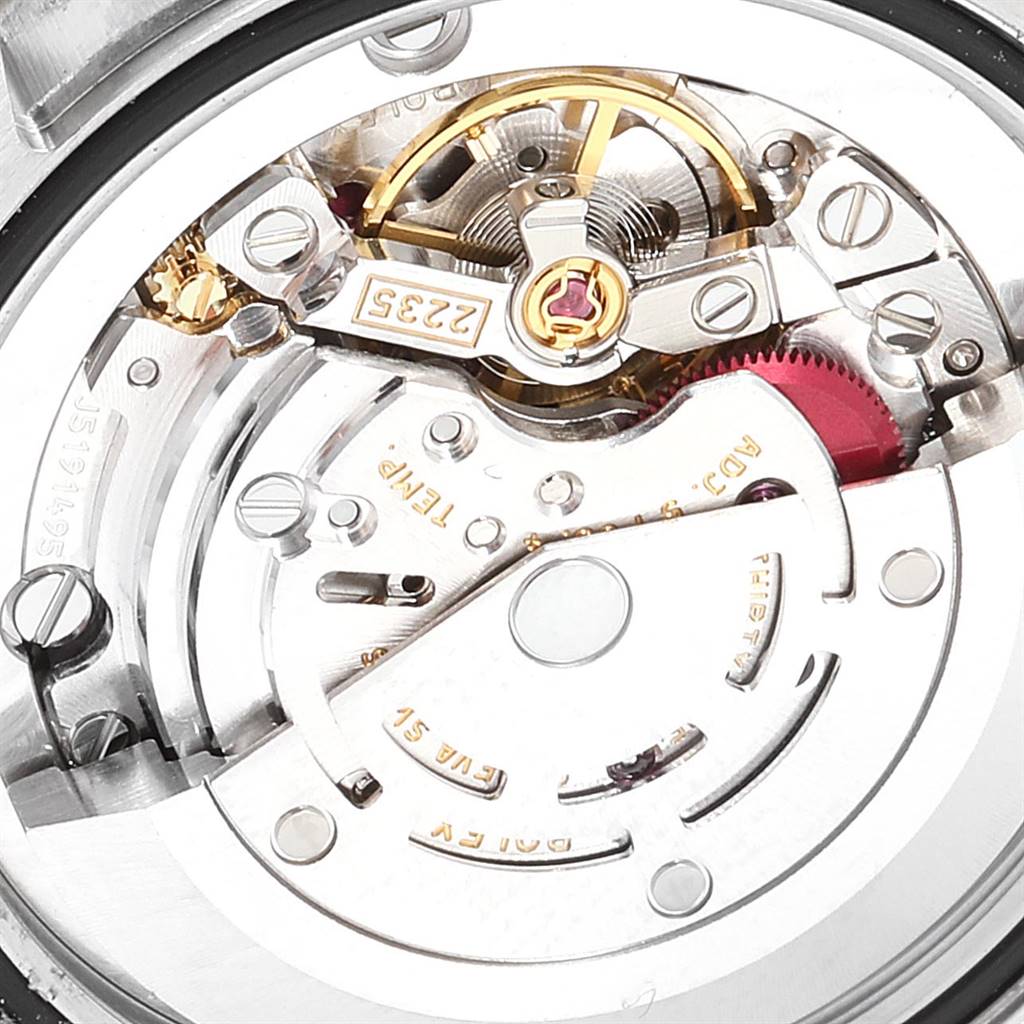 This close-up shot focuses on the internal mechanism and intricate components of a Mid-Size Rolex watch.