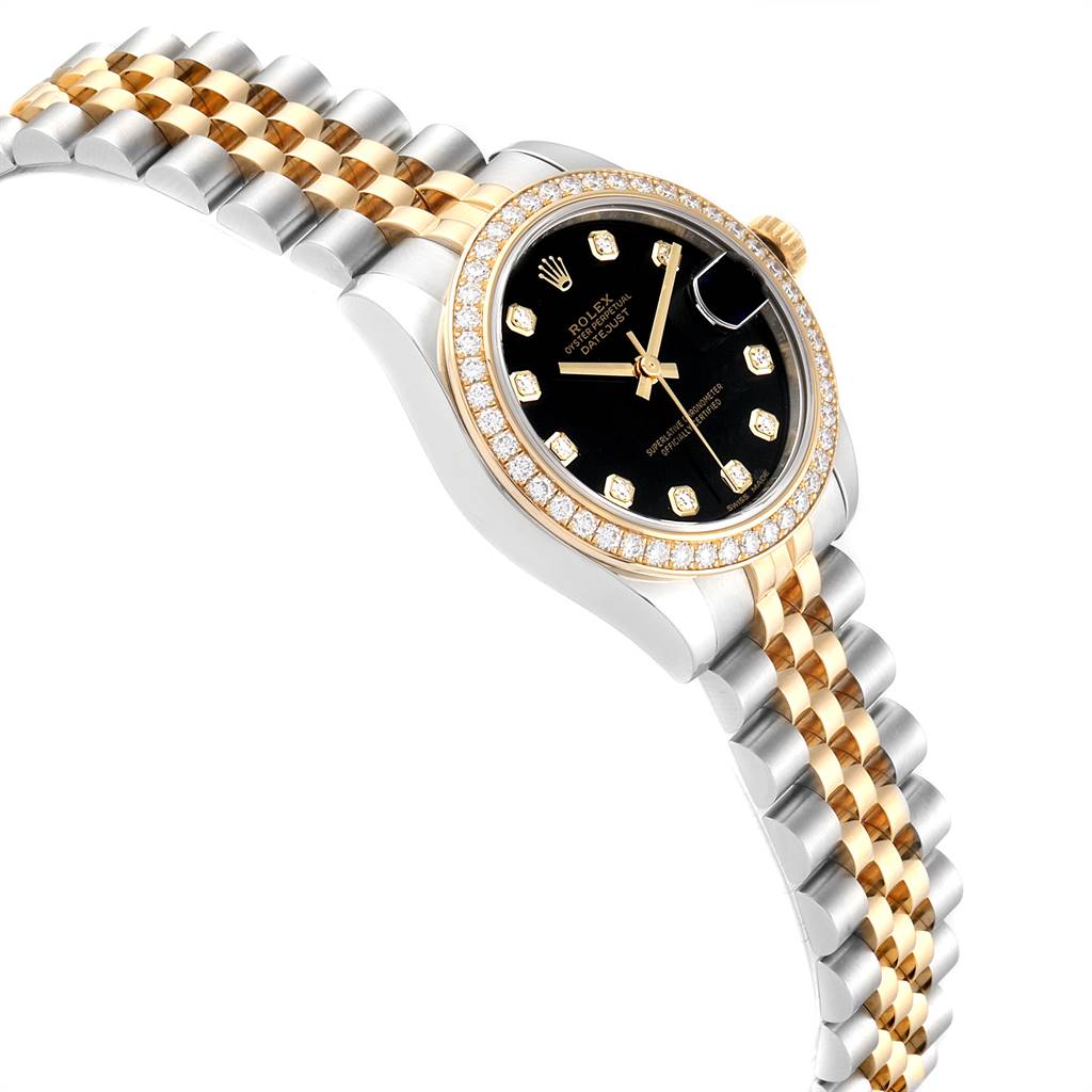 The image shows a side angle of a Rolex Mid-Size 178383 Women's Steel and Gold (two tone) Black Dial 178383 Women's Steel and Gold (two tone) Black Dial watch, highlighting its gold and silver bracelet, black dial, and diamond-encrusted bezel.
