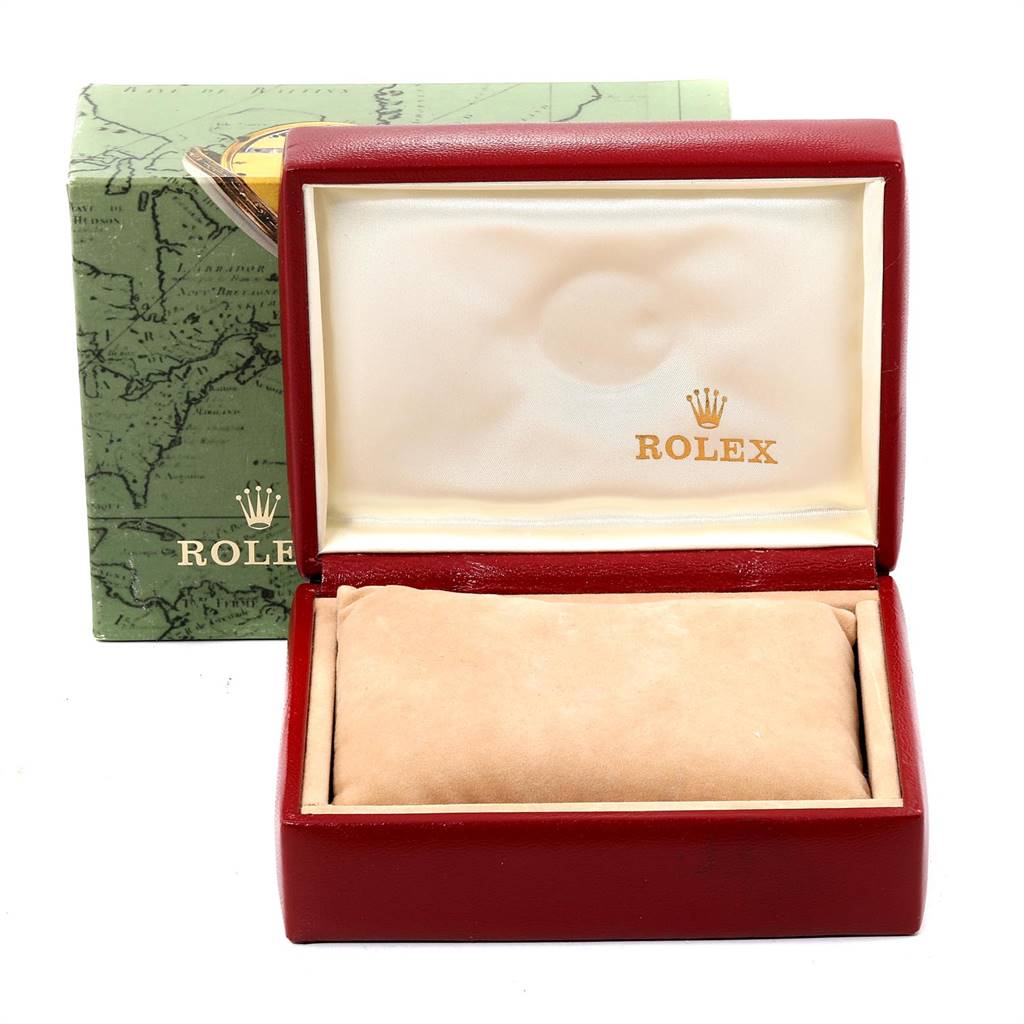 The image shows a red Rolex watch box with the lid open and a beige cushion inside, taken from a front angle.