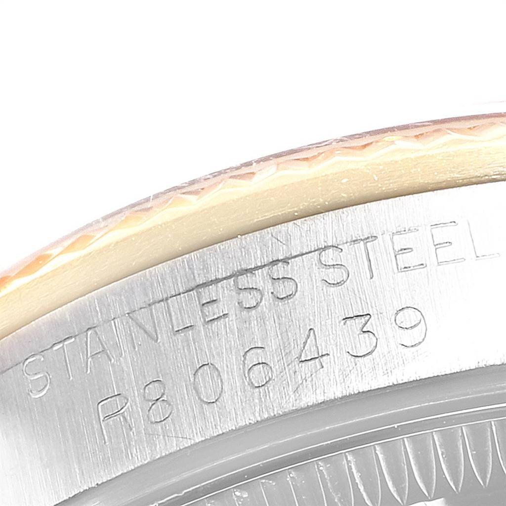 This image shows the side of a Mid-Size Rolex watch's case, focusing on the serial number engraved in the stainless steel.