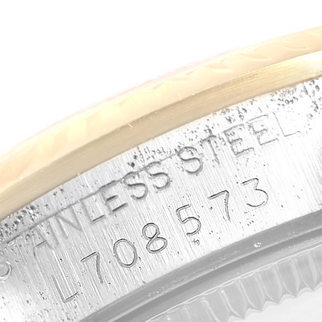 This close-up of the mid-size Rolex watch shows the serial number engraved on the stainless steel case back.