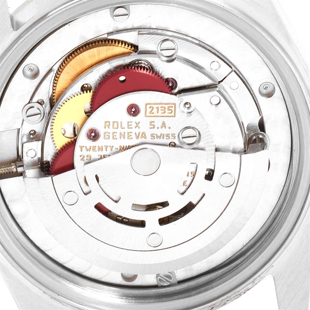 This image shows the intricate internal movement mechanism of a Rolex Mid-Size 68273 Women's Steel and Gold (two tone) Black Dial 68273 Women's Steel and Gold (two tone) Black Dial watch, focusing on gears and the rotor.