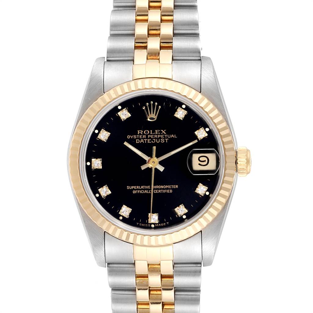 The image shows a front view of a Rolex Datejust Mid-Size watch, featuring a black dial, fluted bezel, and a two-tone bracelet.