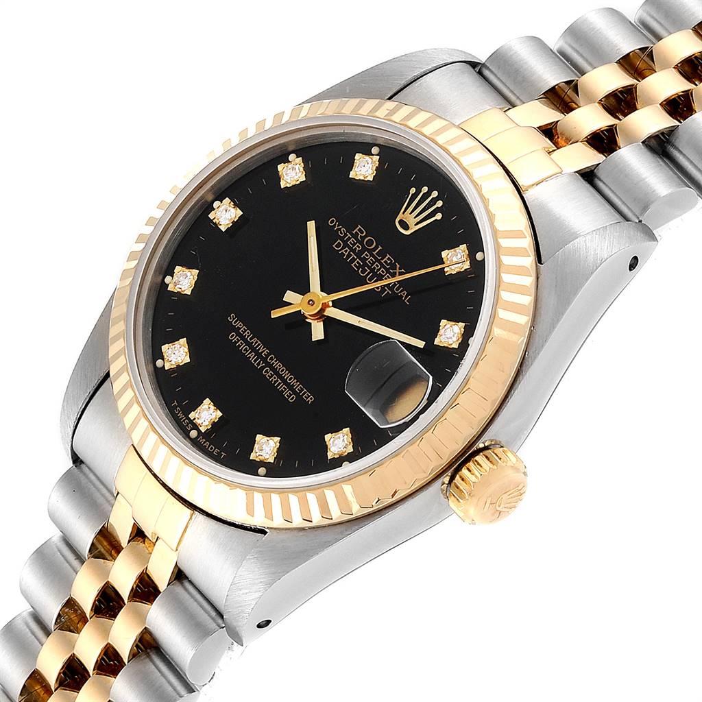 The image shows a Mid-Size Rolex Oyster Perpetual Datejust watch with a black dial, diamond markers, and two-tone band viewed from an angle.