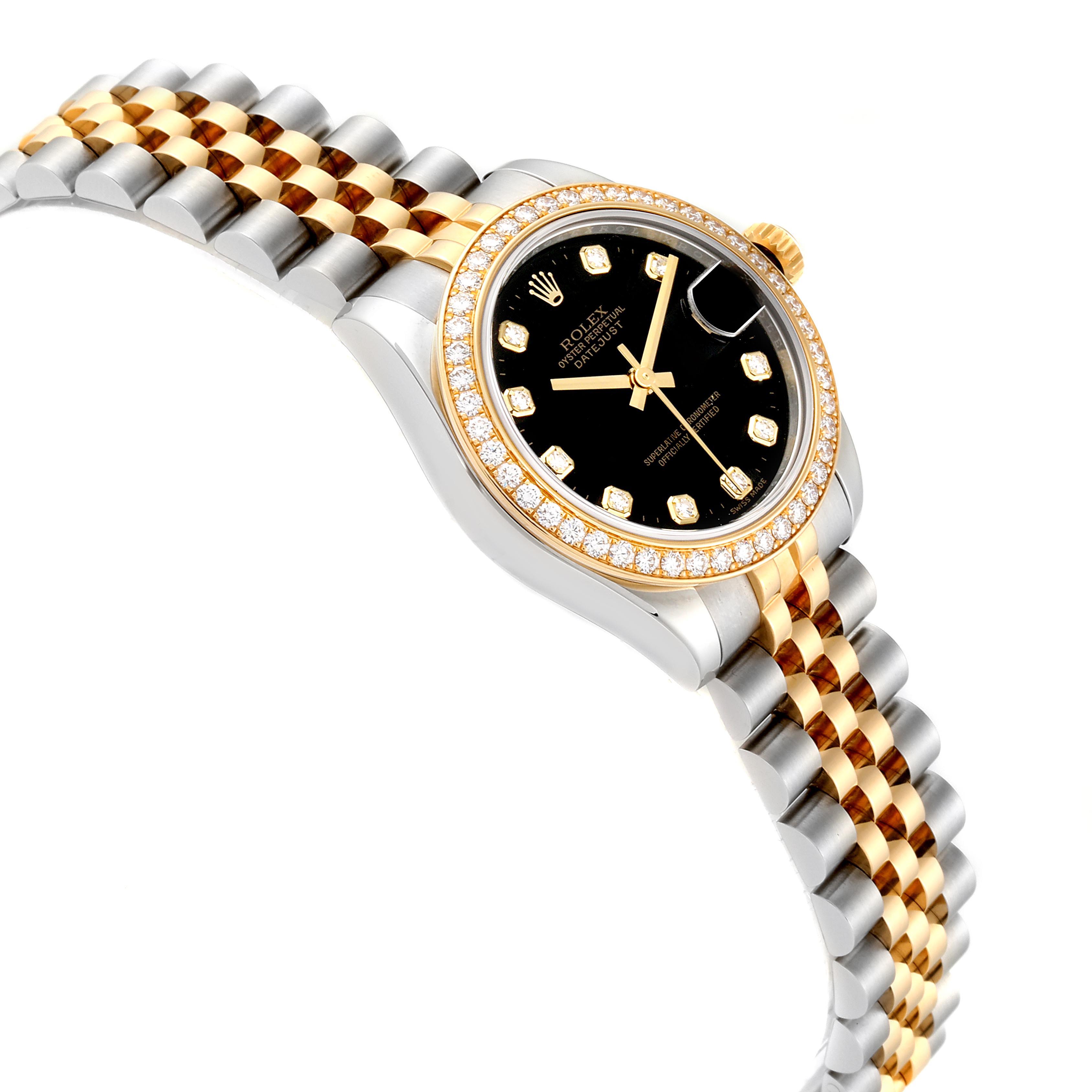 This image shows a side view of a mid-size Rolex watch with a gold and silver band and a black dial surrounded by a diamond bezel.