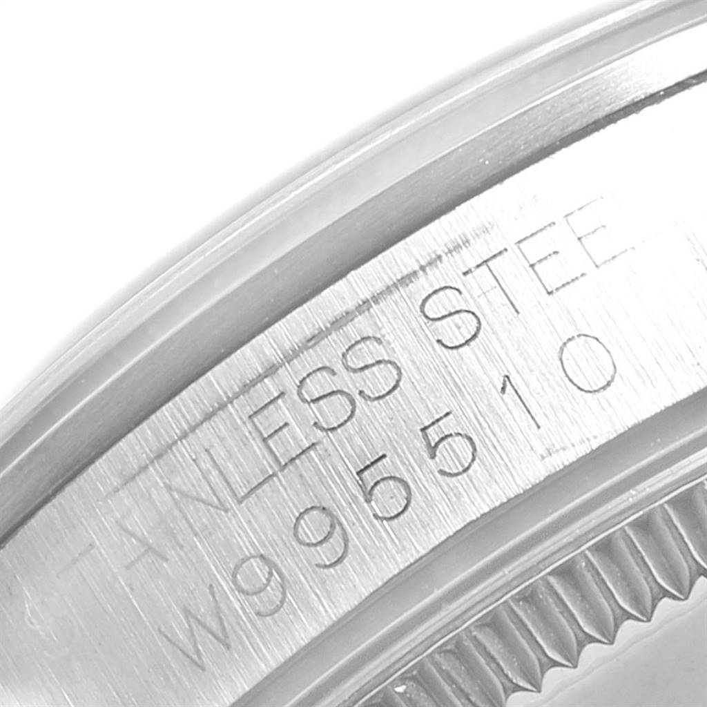 This close-up image shows the serial number and "STAINLESS STEEL" engraving on the casing of a Mid-Size Rolex watch.